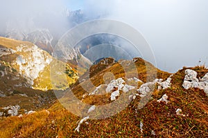 Beautiful autumn colors the cloudy Mangart mountains  in the Julian alps at sunset