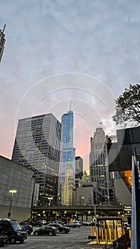 a beautiful autumn day in the city with skyscrapers, office buildings and hotels in the skyline, autumn colored trees and cars