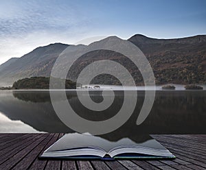 Beautiful Autumn Fall landscape image of Crummock Water at sunrise in Lake District England coming out of pages of book