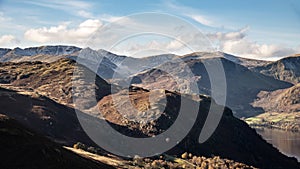 Beautiful Autumn Fall landscape of mountains and hills viewed from Hallin Fell on a crisp cold morning with majestic sunlgiht on