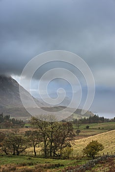 Beautiful Autumn Fall landscape view along valley towards Mellbreak and Grasmoor in Lake District with vibrant epic lighting in photo