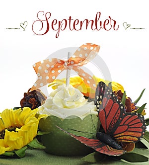 Beautiful Autumn Fall theme cupcake with autumn seasonal flowers and decorations for the month of September