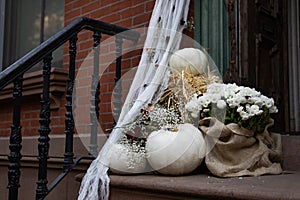 Beautiful Autumn Pumpkin and Flower Display on the Outdoor Stairs of a Brownstone Home in Greenwich Village of New York City