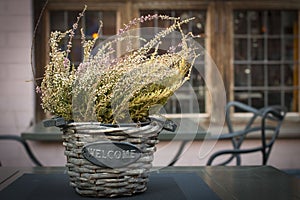 Beautiful autumn heather in a basket with the inscription Wellcome