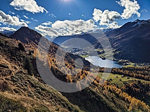 beautiful autumn hike above lake davos. Colored larch forests. Mountain panorama in Davos Klosters Mountains