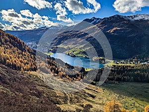 beautiful autumn hike above lake davos. Colored larch forests. Mountain panorama in Davos Klosters Mountains