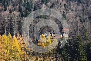 Beautiful autumn landscape with Cantacuzino Palace in the middle of Bucegi mountains forest, Busteni