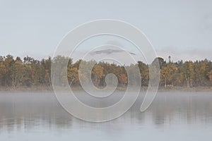 Beautiful autumn landscape with the fog and river