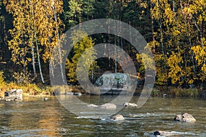 Beautiful autumn landscape with memorial stone on river Kymijoki near the Emperor Alexander lll fishing lodge Langinkoski. Kotka, photo