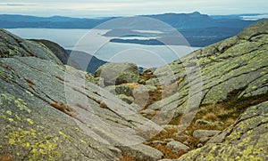 A beautiful autumn landscape of mountains in Folgefonna National park with fjord far in the distance. Fall scenery of southern Nor