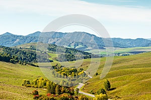 Beautiful autumn landscape. Road, hills and mountains