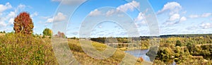 Beautiful autumn landscape with white clouds. Rural place