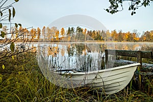 Beautiful autumn morning landscape with old rowing boat and Kymijoki river waters. Finland, Kymenlaakso, Kouvola