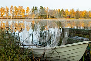 Beautiful autumn morning landscape with old rowing boat and Kymijoki river waters. Finland, Kymenlaakso, Kouvola