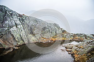 A beautiful autumn mountain landscape with a small lake. Natural scenery in Norwegian mountains.