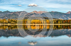 Beautiful autumn mountains reflection on lake Liptovska Mara in Slovakia