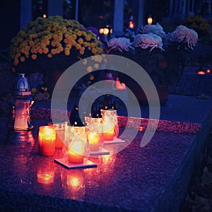 Beautiful autumn night concept. Cemetery and Halloween. Candle in the grave. Background for Halloween.