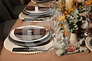 Beautiful autumn place setting and decor for festive dinner on table