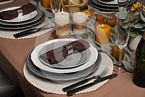 Beautiful autumn place setting and decor for festive dinner on table