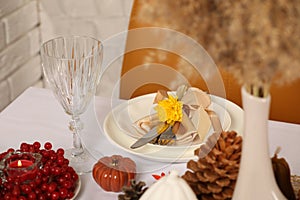 Beautiful autumn place setting and decor for festive dinner on table