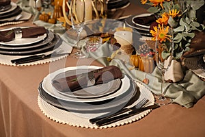 Beautiful autumn place setting and decor for festive dinner on table