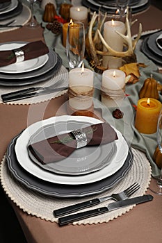 Beautiful autumn place setting and decor for festive dinner on table