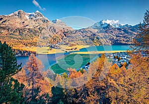 Beautiful autumn scene of Silvaplana village, Maloja Region. Aerial morning view of Swiss Alps with Piz Surlej peak on background.