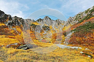 Beautiful autumn scenery of Senjojiki Cirque with rugged peaks in the background
