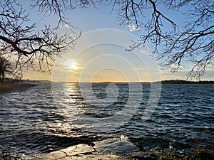 Beautiful autumn seascape sunset view with horizon, sky and sun reflections.