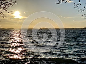 Beautiful autumn seascape sunset view with horizon, sky and sun reflections.