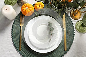 Beautiful autumn table setting. Plates, cutlery, glasses and floral decor, flat lay