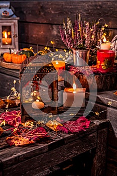Beautiful autumn terrace decoration with pumpkins, lantern, plants and flowers