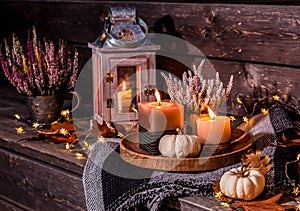 Beautiful autumn terrace decoration with pumpkins, lantern, plants and flowers