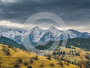 Beautiful autumn with trees under the Tatra Mountains at sunrise. Beautiful landscape in Osturna village.