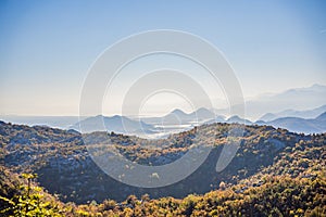 Beautiful autumn view of yellow trees, road and mountains, Montenegro