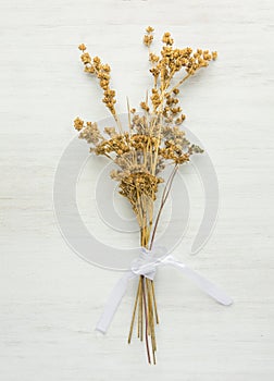 Beautiful Autumnal Easter Wedding Background. Dry Wild Flowers Tied with Silk Ribbon on White Wood. Minimalist Japanese Style