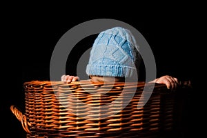 Beautiful babe on a black background in the basket