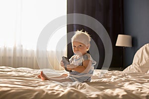 Beautiful baby boy, lying in bed, playing in bed after bath, sleeping