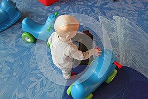 Beautiful baby boy playing at playland