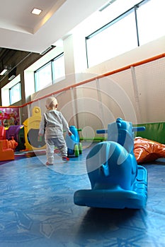 Beautiful baby boy playing at playland