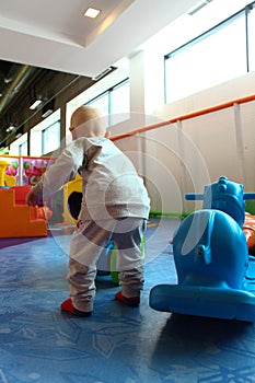 Beautiful baby boy playing at playland