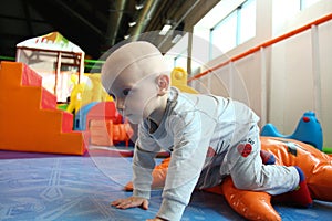 Beautiful baby boy playing at playland