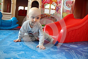 Beautiful baby boy playing at playland