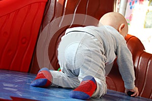 Beautiful baby boy playing at playland