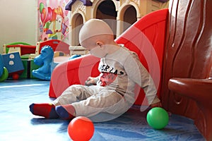 Beautiful baby boy playing at playland