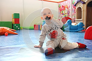 Beautiful baby boy playing at playland