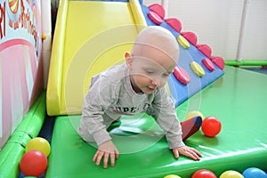 Beautiful baby boy playing at playland