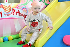 Beautiful baby boy playing at playland