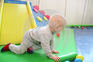 Beautiful baby boy playing at playland