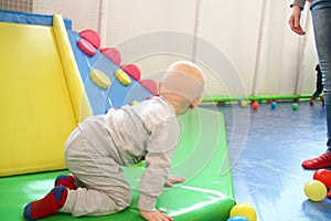 Beautiful baby boy playing at playland